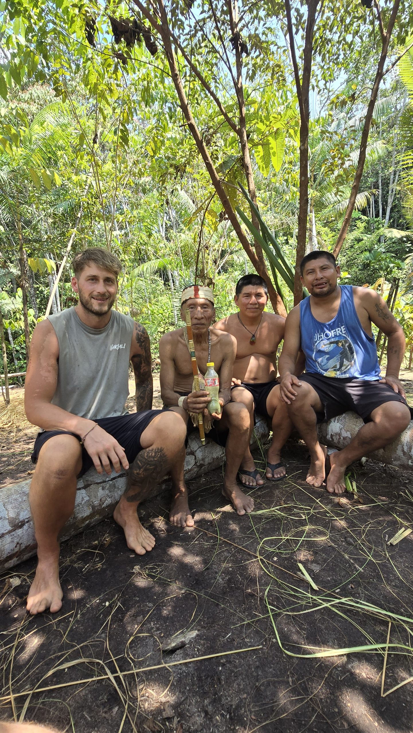 Warriors Wellbeing practitioner seated with members of the Matsés community in the Amazon